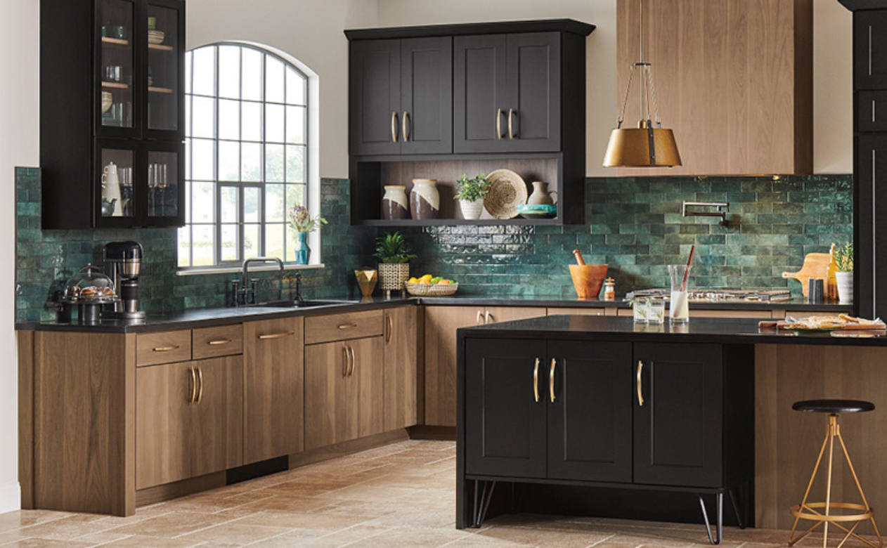 Kitchen with black and natural cabinetry and green backsplash